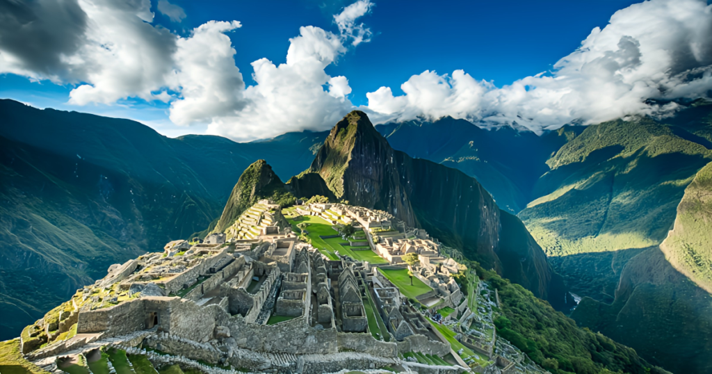 Panoramic view of Machu Picchu ruins with Huayna Picchu mountain towering in the background.