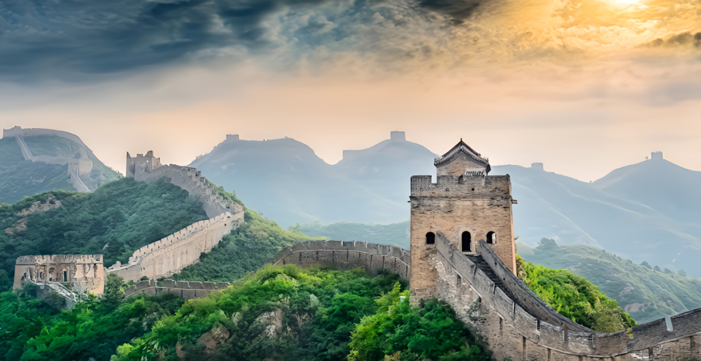 Section of the Great Wall of China winding across mountain ridges under an overcast sky.